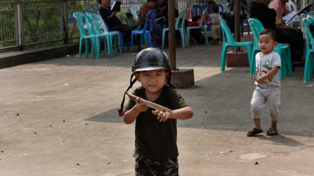 Five-year old Zai Zin Awng, with a toy gun imitates a Kachin rebel as he plays outside a Baptist church in Laiza, the headquarters of the Kachin Independence Army in northern Kachin State, Myanmar. 
