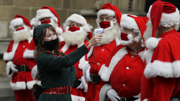 Santas have their temperature tested at a training course in London.