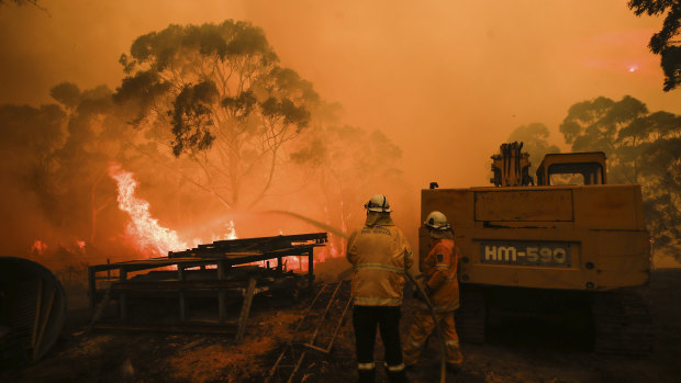 RFS firefighters tackle a fire at Bombay, NSW. The market operator has warned of blackout risks during a forecast hot summer.