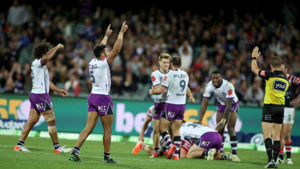 Storm celebrate a hard-fought win over the Roosters on Friday night.