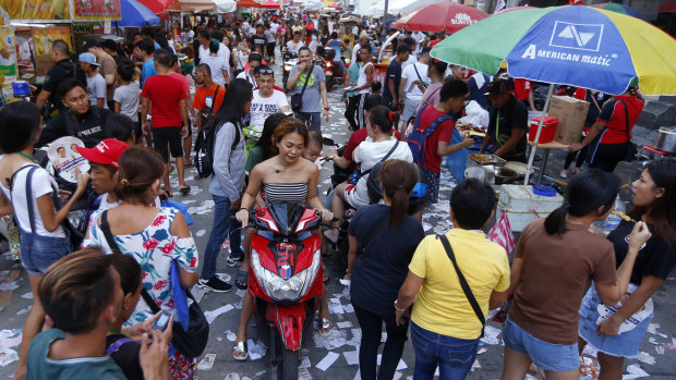 Election campaign materials litter the street as the country's midterm elections draw to a close in Manila.