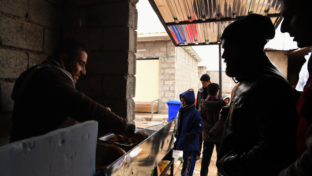 This particular falafel, served in in Daquq IDP camp in Kirkuk, is served in bread rolls with hot chips, tomatoes and onions. 