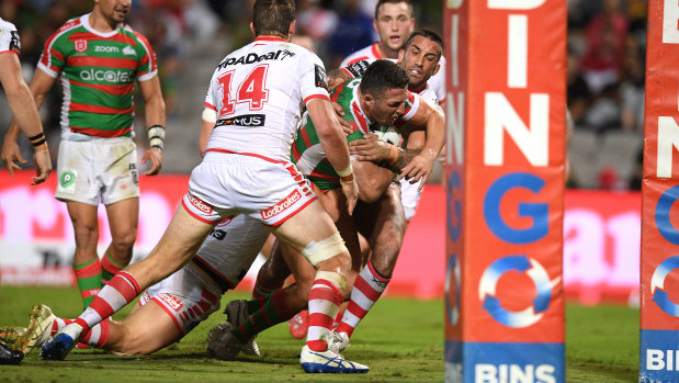 Powerhouse performance: Sam Burgess pushes through a tackle to score a try.