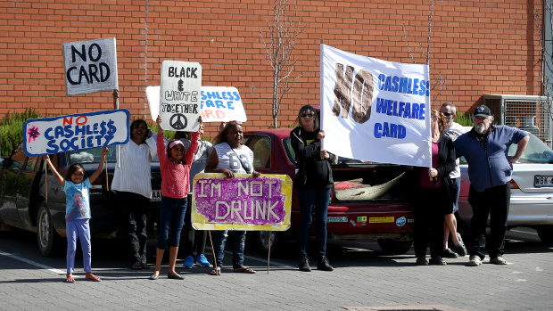 Protesters waiting to greet Prime Minister Malcolm Turnbull during a visit to a supermarket in Ceduna to view a demonstration of the cashless debit card in 2016.