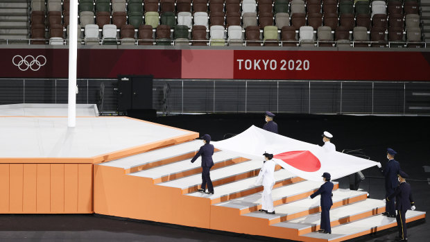Japanese national flag is carried into the stadium during the Closing Ceremony of the Tokyo 2020 Olympic Games.