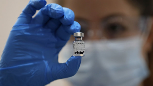 A nurse holds a phial of vial of the Pfizer-BioNTech vaccine - one of two products being rolled out in the UK.