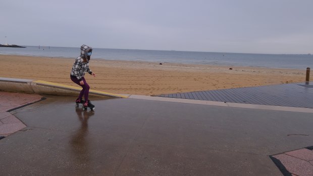  A lone rollerskater at a mostly abandoned St Kilda beach on Saturday.