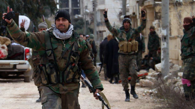 Syrian army soldiers flash the victory sign in the Rashideen neighbourhood, in Aleppo province, Syria, on February 16.