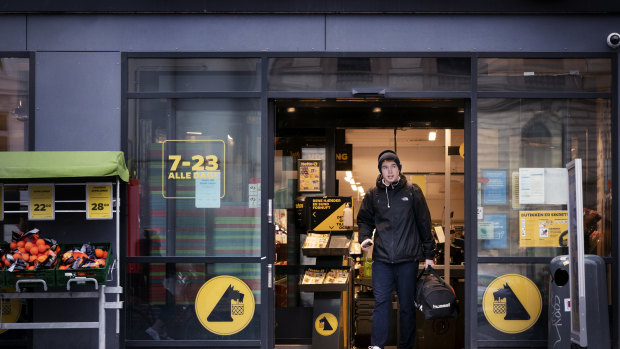 Life goes on in Denmark as a customer exits a supermarket in Copenhagen. 