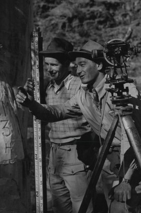 Assistant Survey Chief Harry Stacey and his assistant, Jack Robinson, prepare to work out from a bench mark at the Adaminaby dam  site. 