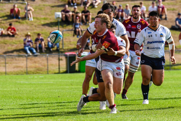 Harry McLaughlin-Phillips, pictured taking on the Saitama Wild Knights, offloads for the Queensland Reds.