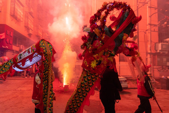 People prepare for a festival in China, where the government wants economists to talk up its economy. 