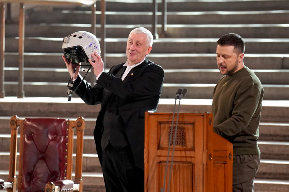 Speaker of the House of Commons Lindsay Hoyle accepts the gift of a fighter pilot’s helmet from Ukrainian President Volodymr Zelensky.