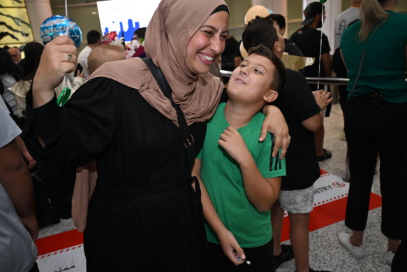 Families embrace at Sydney Airport. 