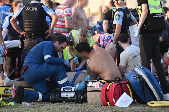 Emergency Services attend to wounded at the site of a multiple shooting at Bondi Beach.