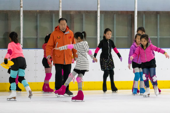 Figure skating coach Jing Dehua runs a training session in Beijing. The Chinese government hopes 300 million people will take up winter sports.