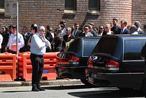 Twin hearses left the funeral for Rookwood with a police escort.