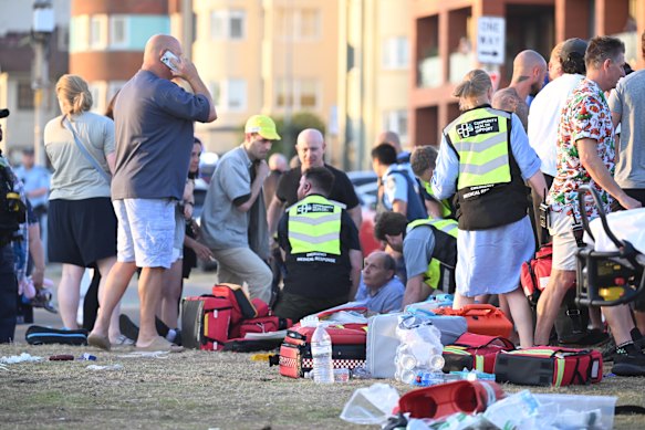 First responders and bystanders tend to victims at Bondi Beach, 