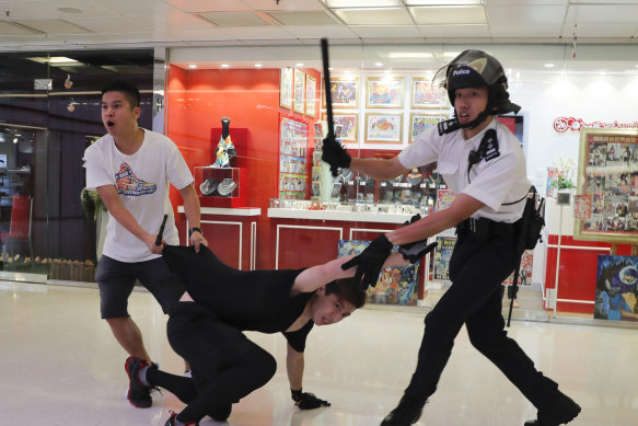 Police detain a young man in Amoy Plaza.