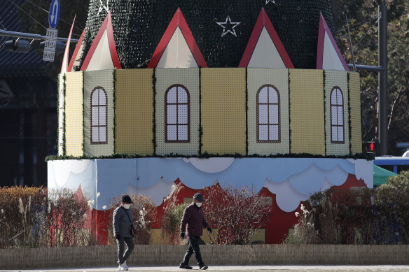 People walk near a Christmas decoration in Seoul, South Korea, on Thursday.