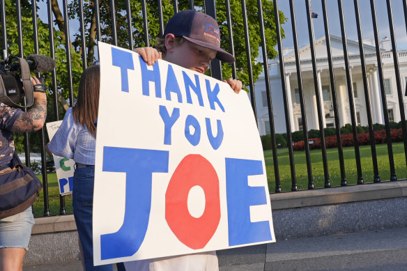 Hugh Kieve, 10, holds a sign outside the White House after Joe Biden said he wouldn’t contest the US election. 