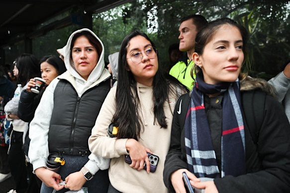 Karen Ortiz, Michelle Ortiz and Angie Carreno wait for a replacement bus at Strathfield station.