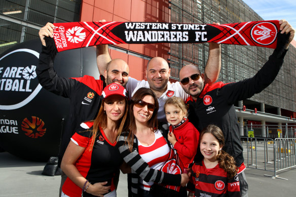 Western Sydney Wanderers fans Linda Zinghini, Rosie Daminao, Olivia Damiano, 3, Isabella Damiano, 8, (Back L-R) Mark Fazio, Frank Damiano and Steve Damiano, all from Western Sydney, have flown up for the Grand Final at Suncorp Stadium.