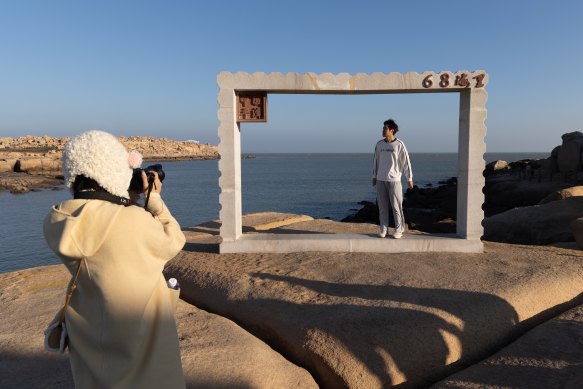 University students on Houyan island pose at the closest point between the mainland and Taiwan’s main island. Taiwan is 68 nautical miles away from Houyan. 