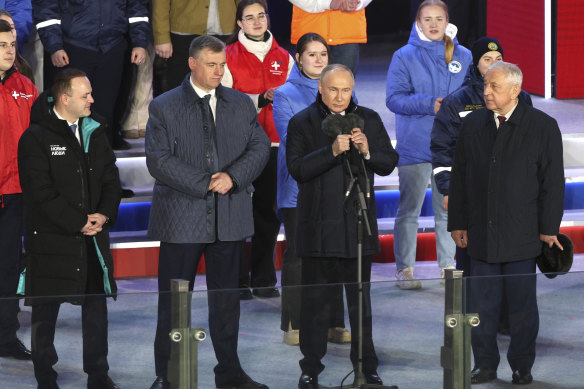 Vladimir Putin speaks next to candidates who ran in the Russian presidential elections against him, Vladislav Davankov, left, Leonid Slutsky, second left and Nikolai Kharitonov, right. 