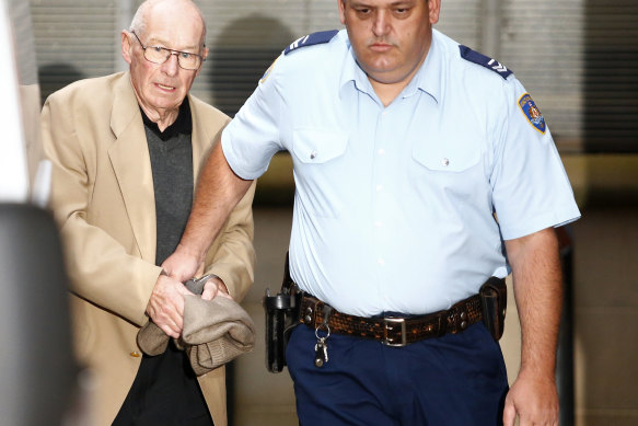 Roger Rogerson is escorted out of court during his trial for murder in 2016.