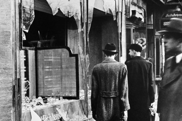Berliners inspect the damage to a Jewish-owned shop following the infamous Kristallnacht pogrom in November 1938.