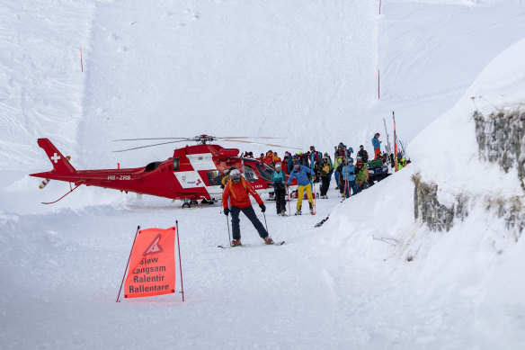 Rescuers search for possible victims after an avalanche swept down a ski piste in Andermatt, Switzerland.