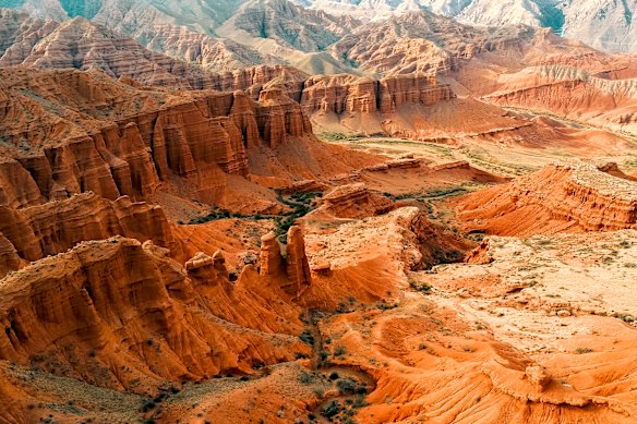 The red rock landscape behind Issyk-Kul.
