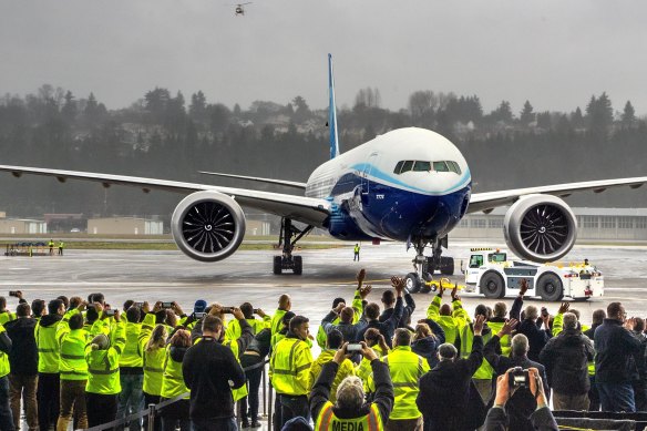 Boeing employees and family members cheer the 777X at Boeing Field in Seattle after it completed its maiden flight.