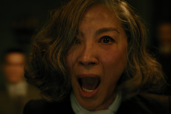 Michelle Yeoh as famous spiritualist  Joyce Reynolds in A Haunting in Venice.