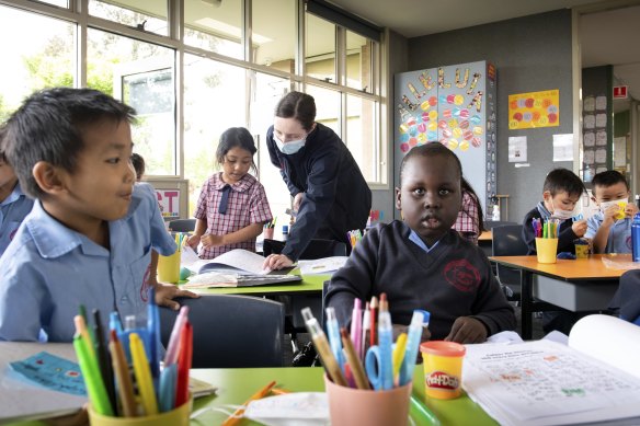 Resurrection prep student Lynaki, 6, reads to teacher Sophie Burke on Monday.