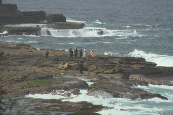 Rescuers on the rocks at Little Bay.