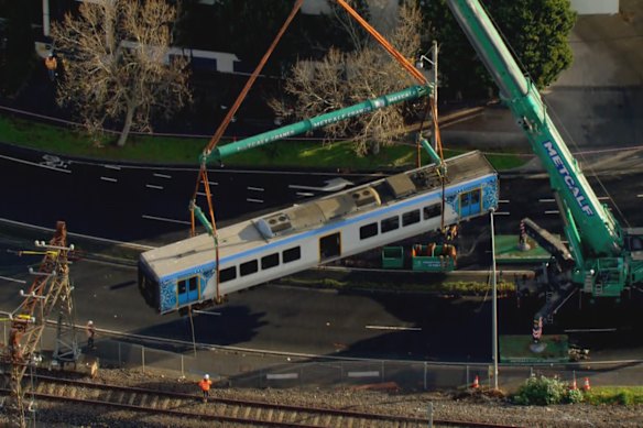 The train car has been raised by tracks via crane on tuesday. 