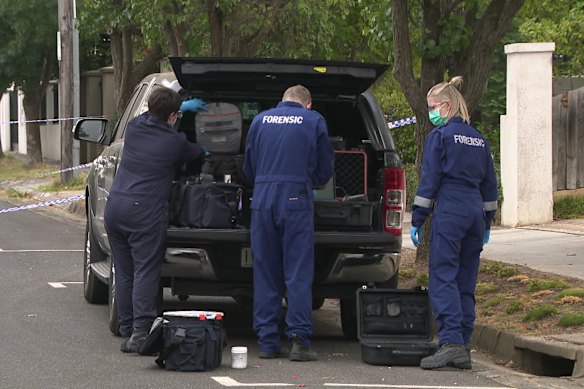 Police at the scene where a woman was stabbed at Miller Grove in Kew.