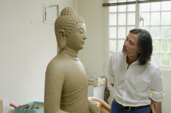 Taiwanese-American artist Lee Mingwei inspecting his partially-completed work, Spirit House 2022, which will sit in an alcove in the rammed earth wall in Sydney Modern.  