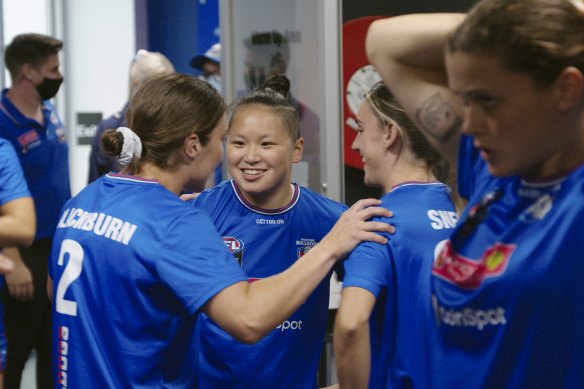 Amanda Ling (centre) with her Bulldogs teammates in a scene from Fearless: The Inside Story of the AFLW.