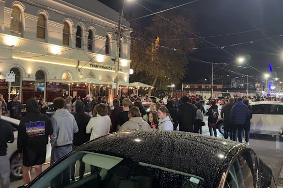People gather near the corner of Chapel and Simmons streets in South Yarra on Saturday night.