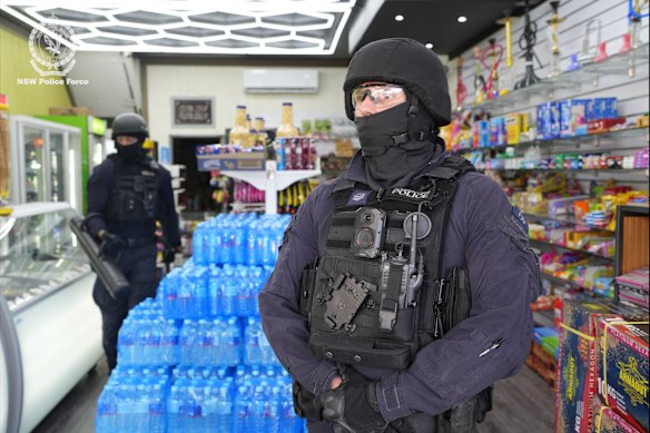 Police at the Mount Pritchard tobacconist during a raid earlier this year.