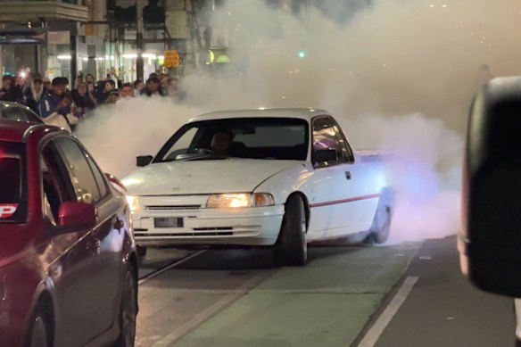 A car does a burnout on Chapel Street on Saturday night. 