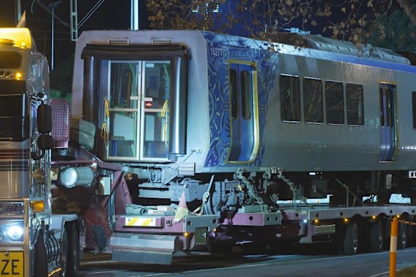 The derailed carriage is removed by truck on Tuesday evening.
