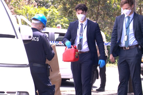 A detective leave Lewis’ Continental Kitchen with a jerrycan on Sunday afternoon. 