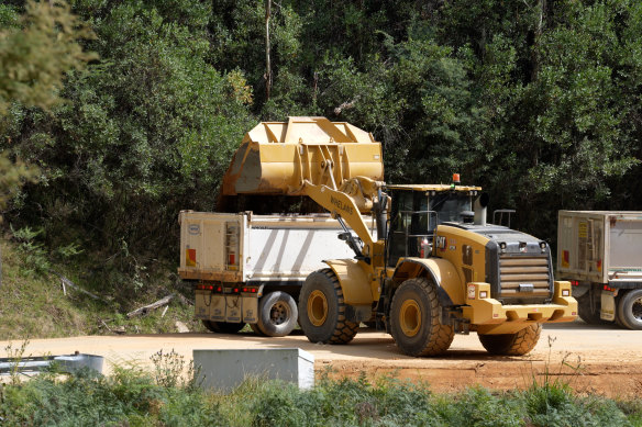 Earth moving equipment clearing the landslide on the Bogong High Plains Road. 