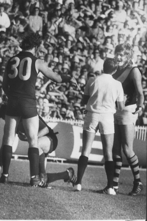 Umpire Ian Robertson speaks to Balme after a clash with Carlton’s Kevin Hall during the 1973 grand final.