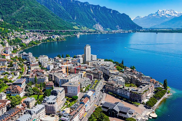 a high-angle aerial perspective of Montreux, a picturesque resort town located along the eastern shore of Lake Geneva in Switzerland. 