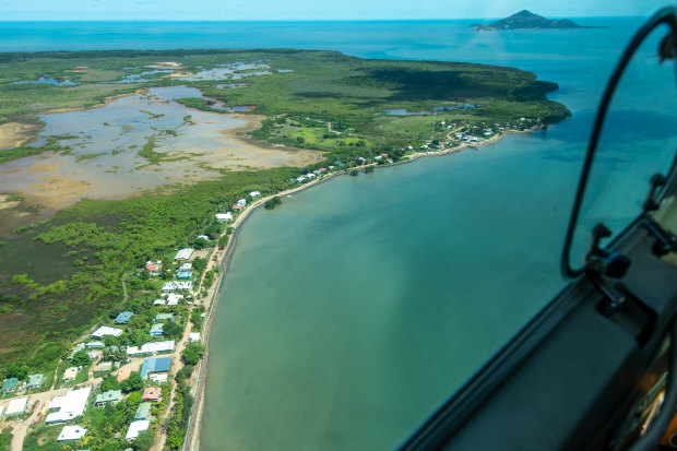 Flying into Saibai Island. Its $24 million sea wall was breached less than six months after its completion. During storm surges, the sea sluices under homes.